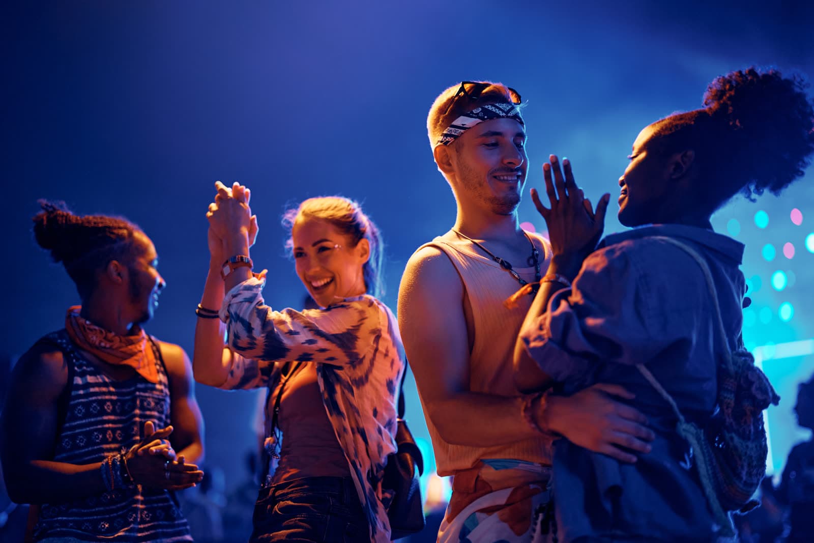 Friends dancing together at a night show