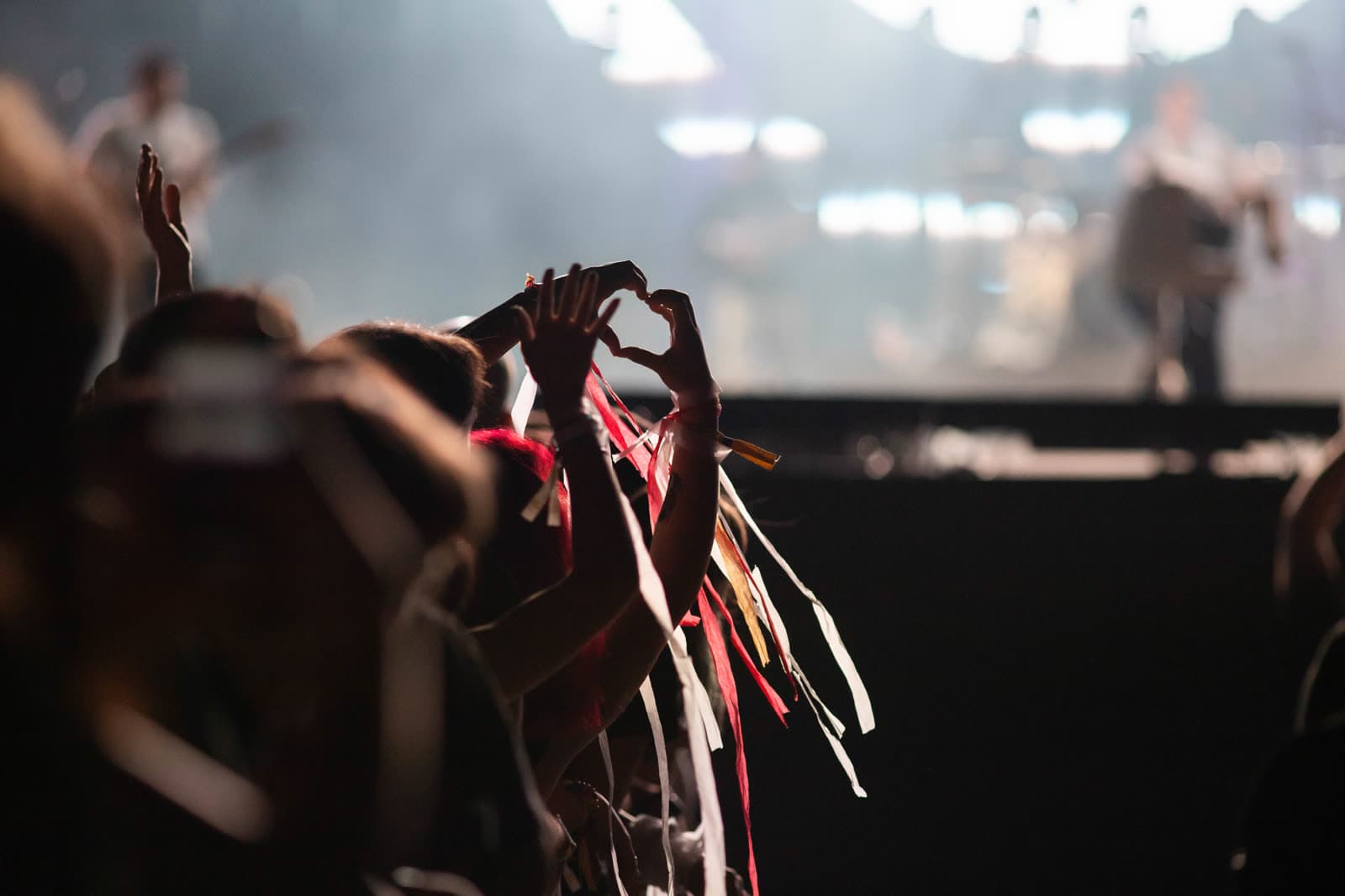 Fans holding streamers up at a show