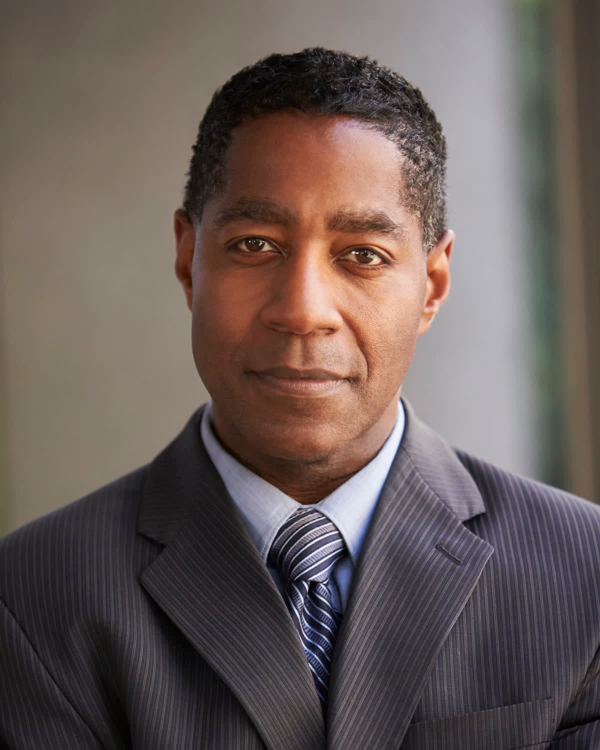 An attorney in a pinstripe suit and striped tie