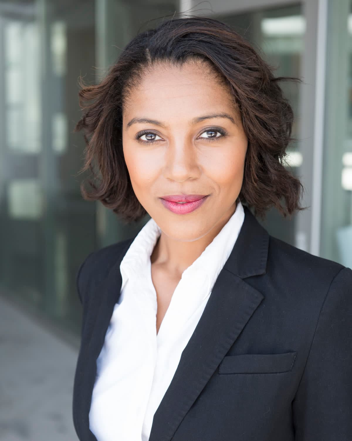 An attorney in a dark suit and white blouse