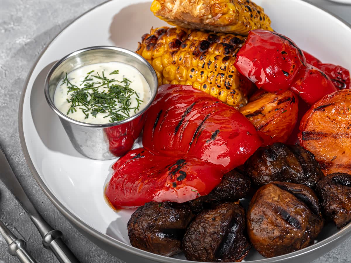 Charred peppers, corn and mushrooms with a dill dip